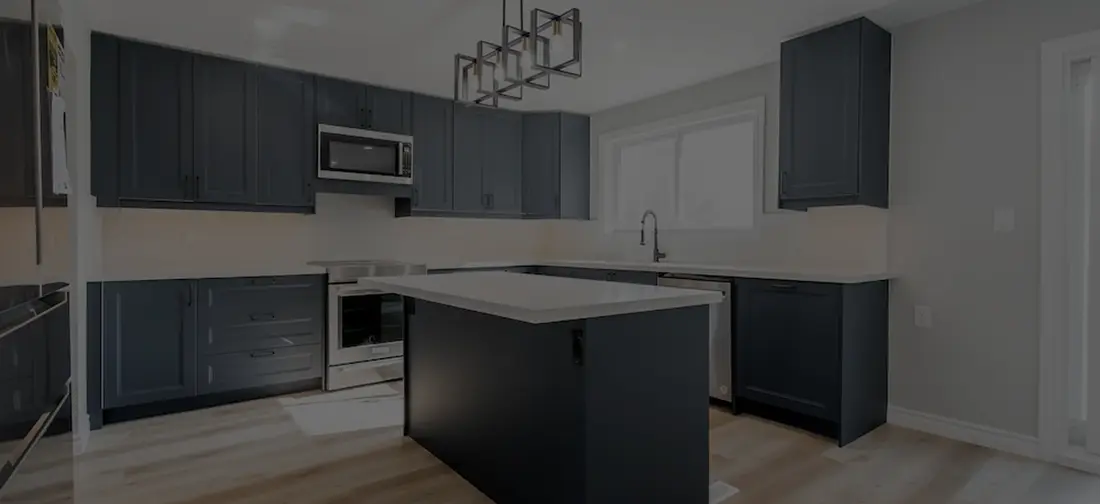 Navy kitchen with a large island and white walls in an Innisfil home