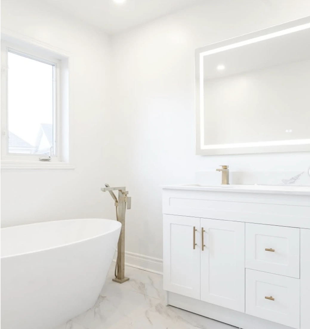 Bright minimalist bathroom with freestanding bathtub and gold accents