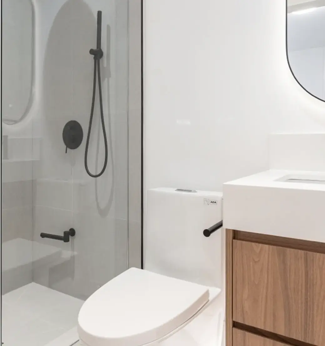 Bathroom with a walnut vanity and glass walk-in shower near Oshawa