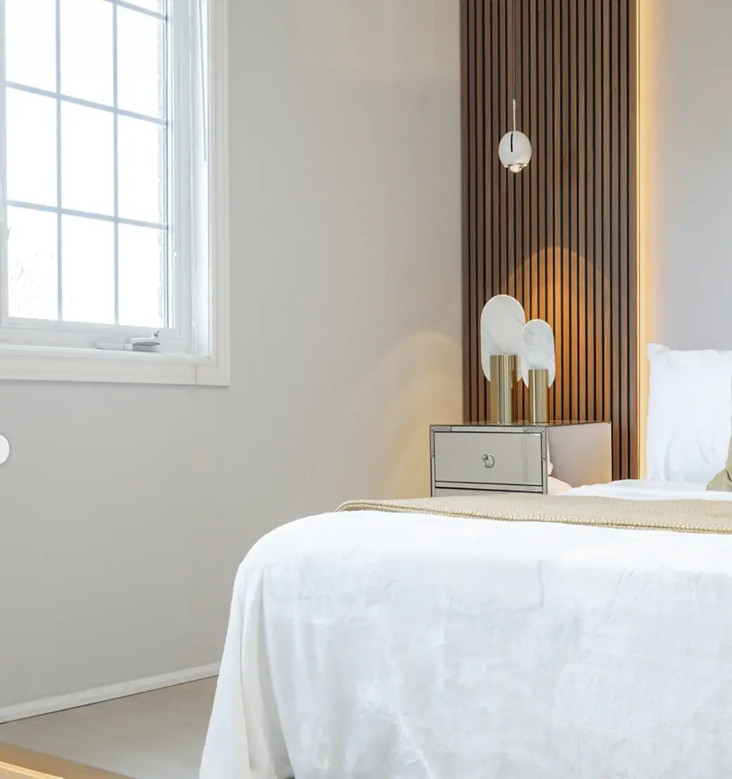 Primary bedroom with a wood slat accent wall near Pickering