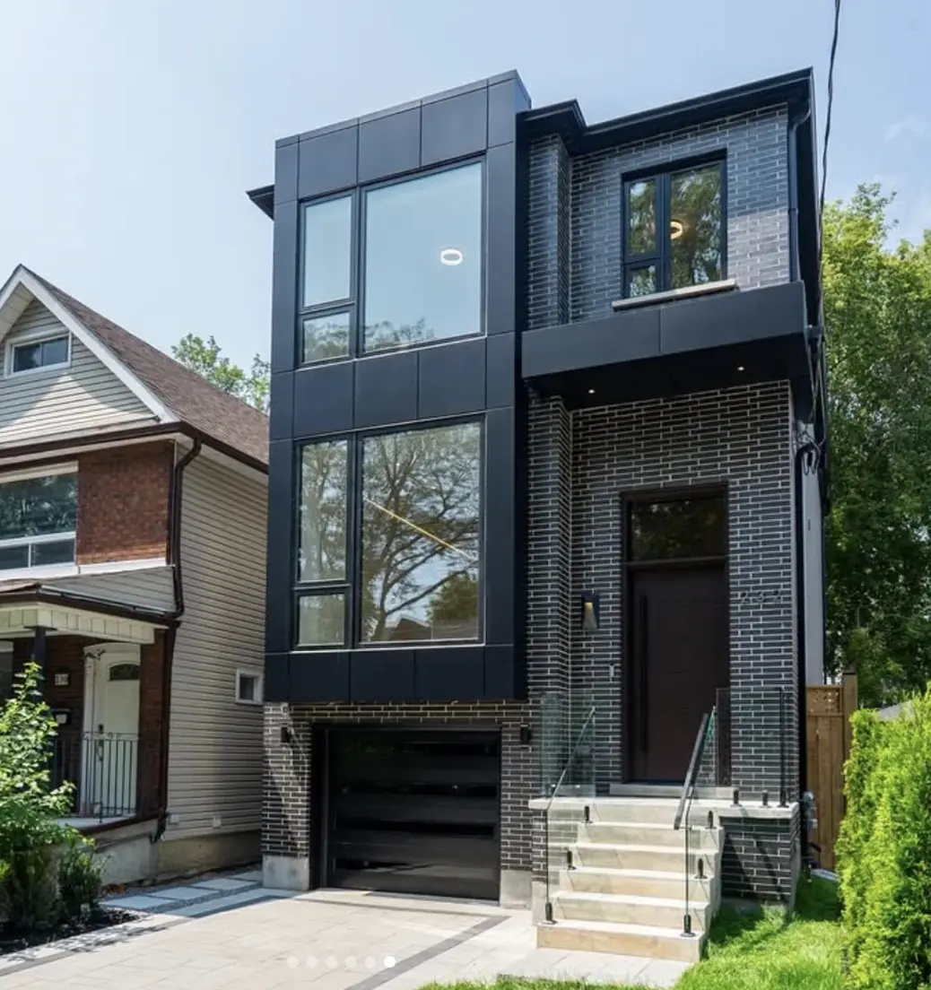 Modern three-storey home with dark cladding and large windows