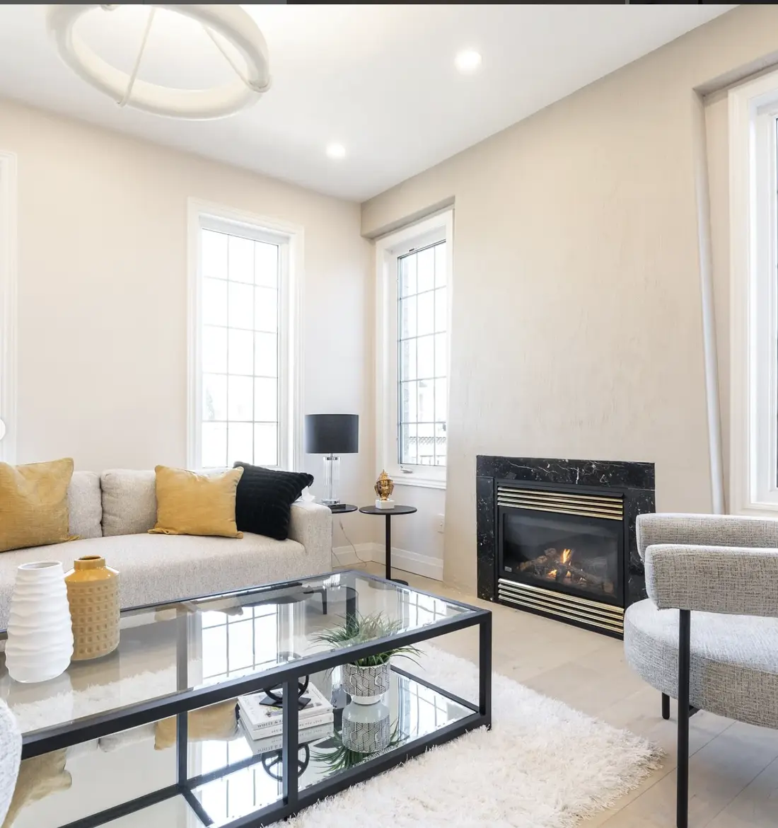 Bright living room with a fireplace and neutral furnishings near Milton