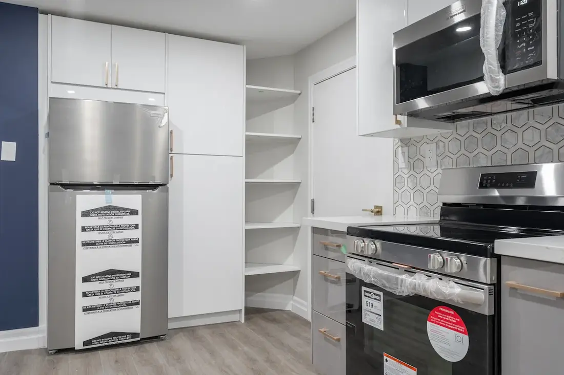Renovated kitchen with a built-in pantry and hexagon tile backsplash in an Oshawa home