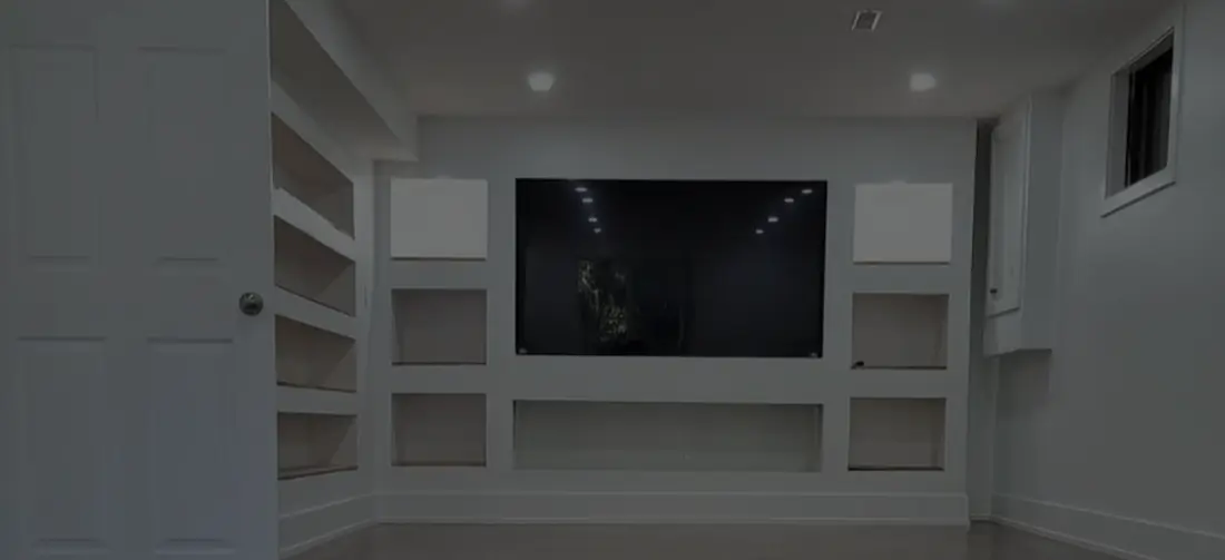 Finished basement recreation room with built-in shelving near Oshawa