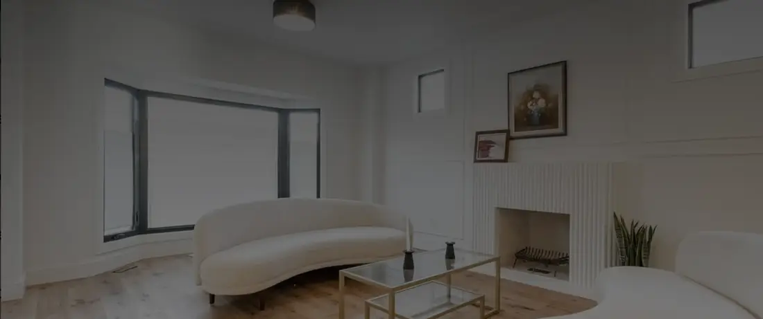 Bright living room with a fireplace and wide-plank oak floors
