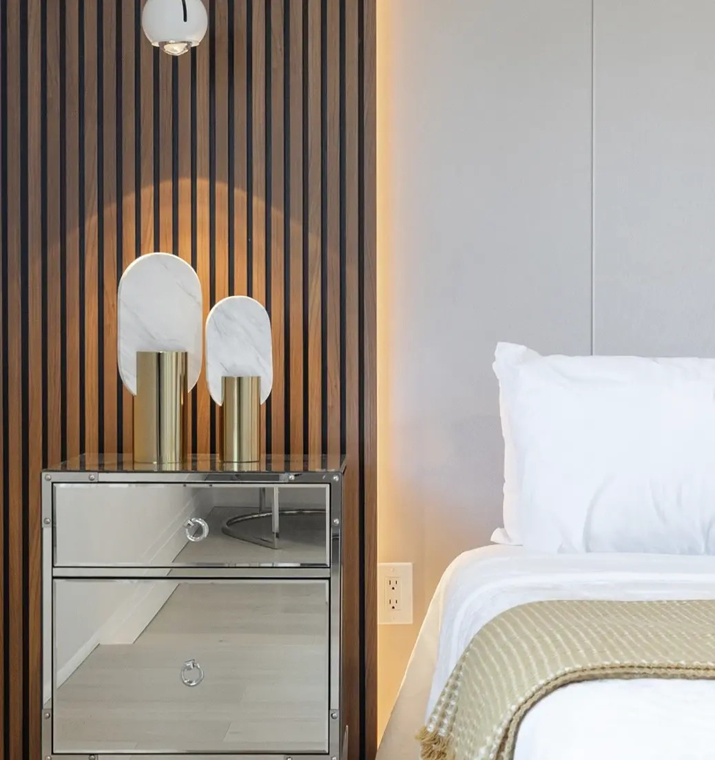 Bedroom with a slatted wood wall and mirrored dresser near Orangeville