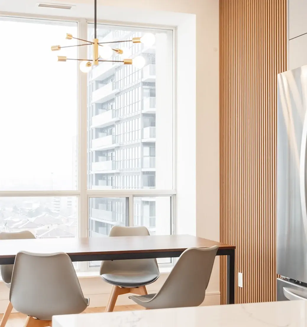Dining area with a wood feature wall and large windows near Innisfil