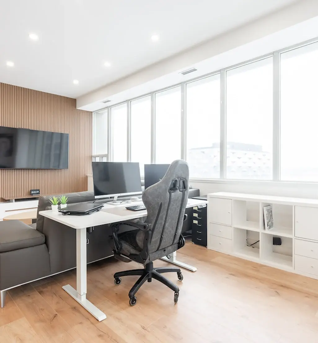 Home office with a standing desk and built-in storage in a Waterloo home