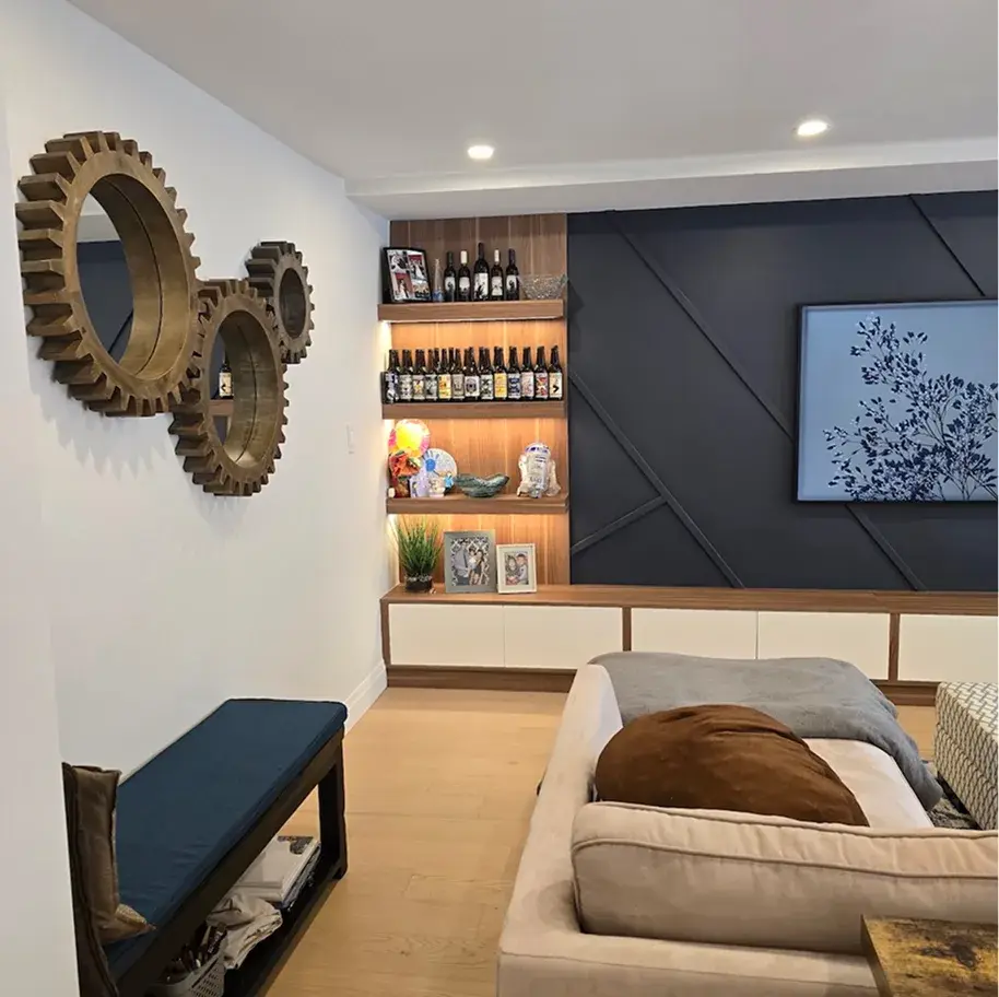 Living room with a wood feature wall and decorative mirrors near Waterloo