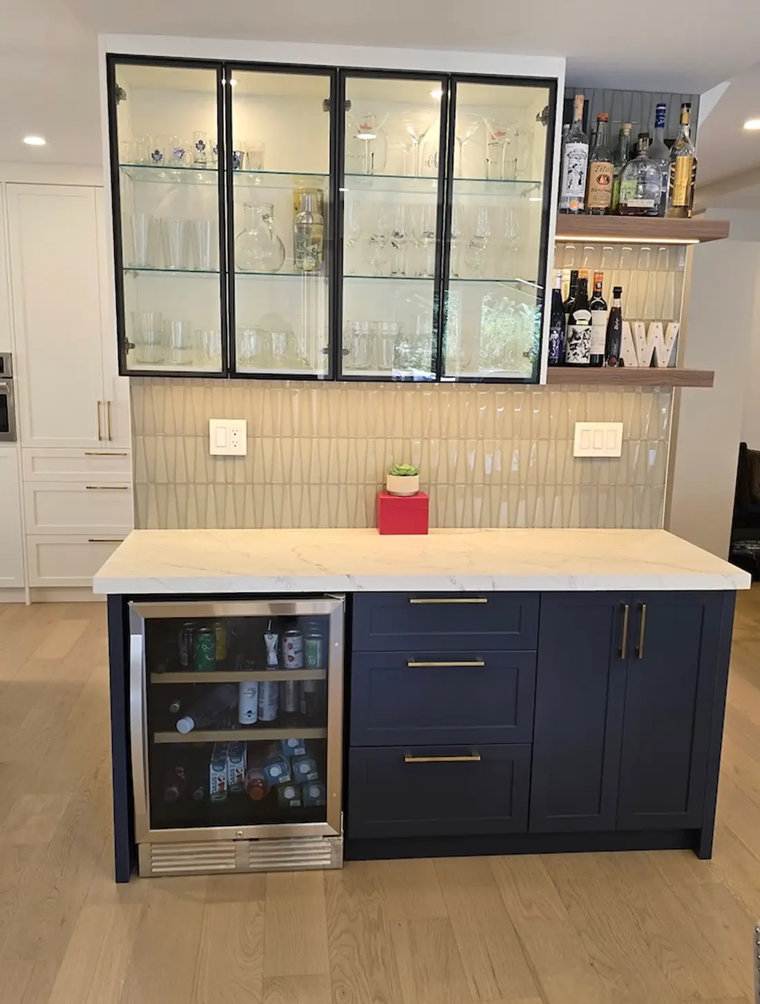 Navy bar cabinetry with glass upper doors in an Orangeville home