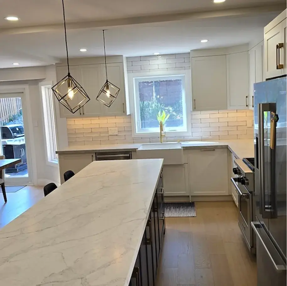 White kitchen with marble countertops and pendant lighting near Whitby