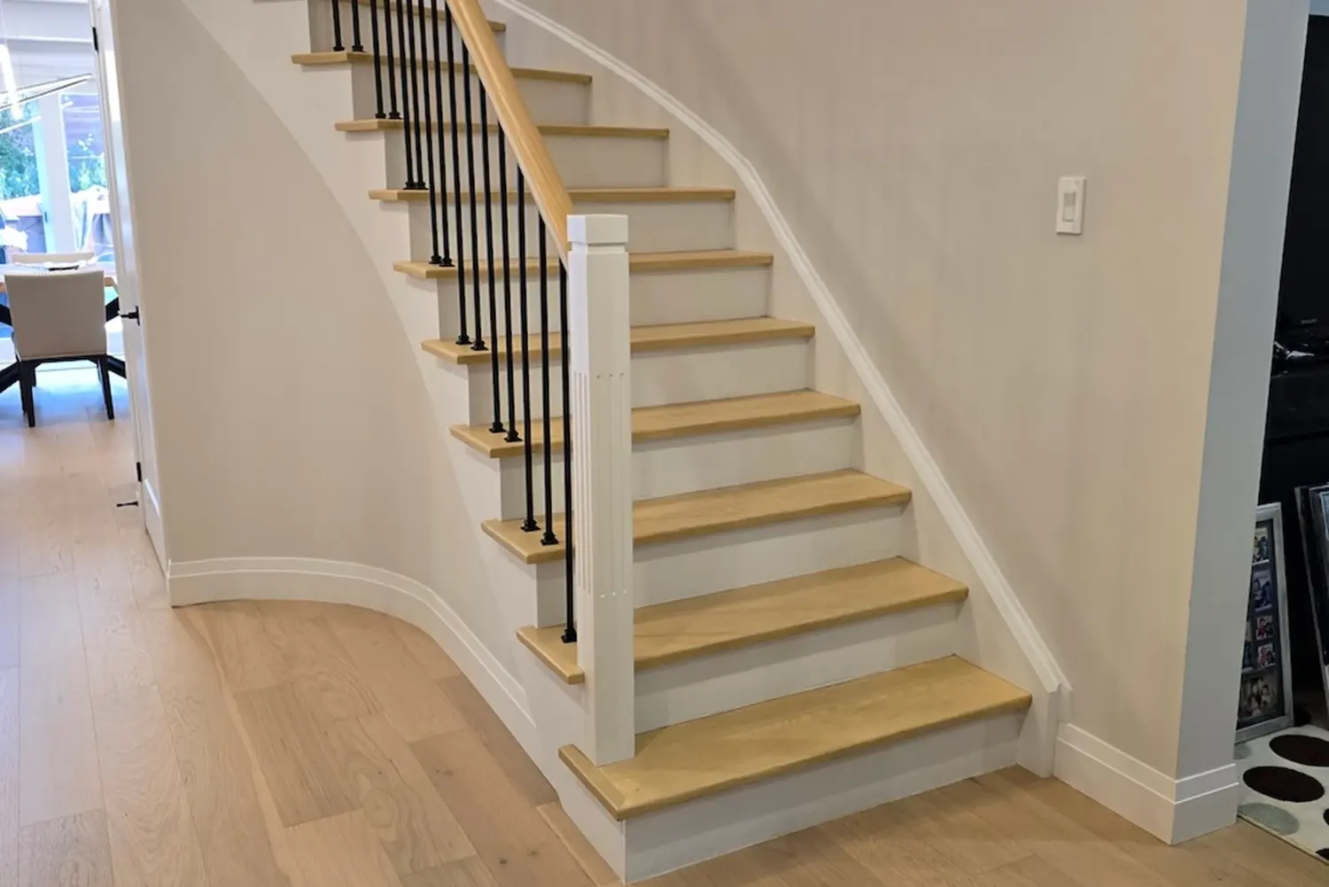 Hardwood staircase with black railings near Newmarket