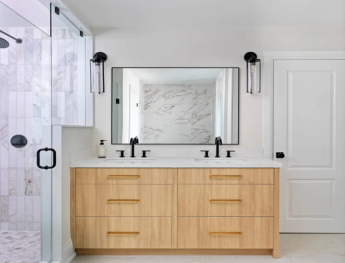 Double vanity with wood cabinetry and marble counter in a Toronto home