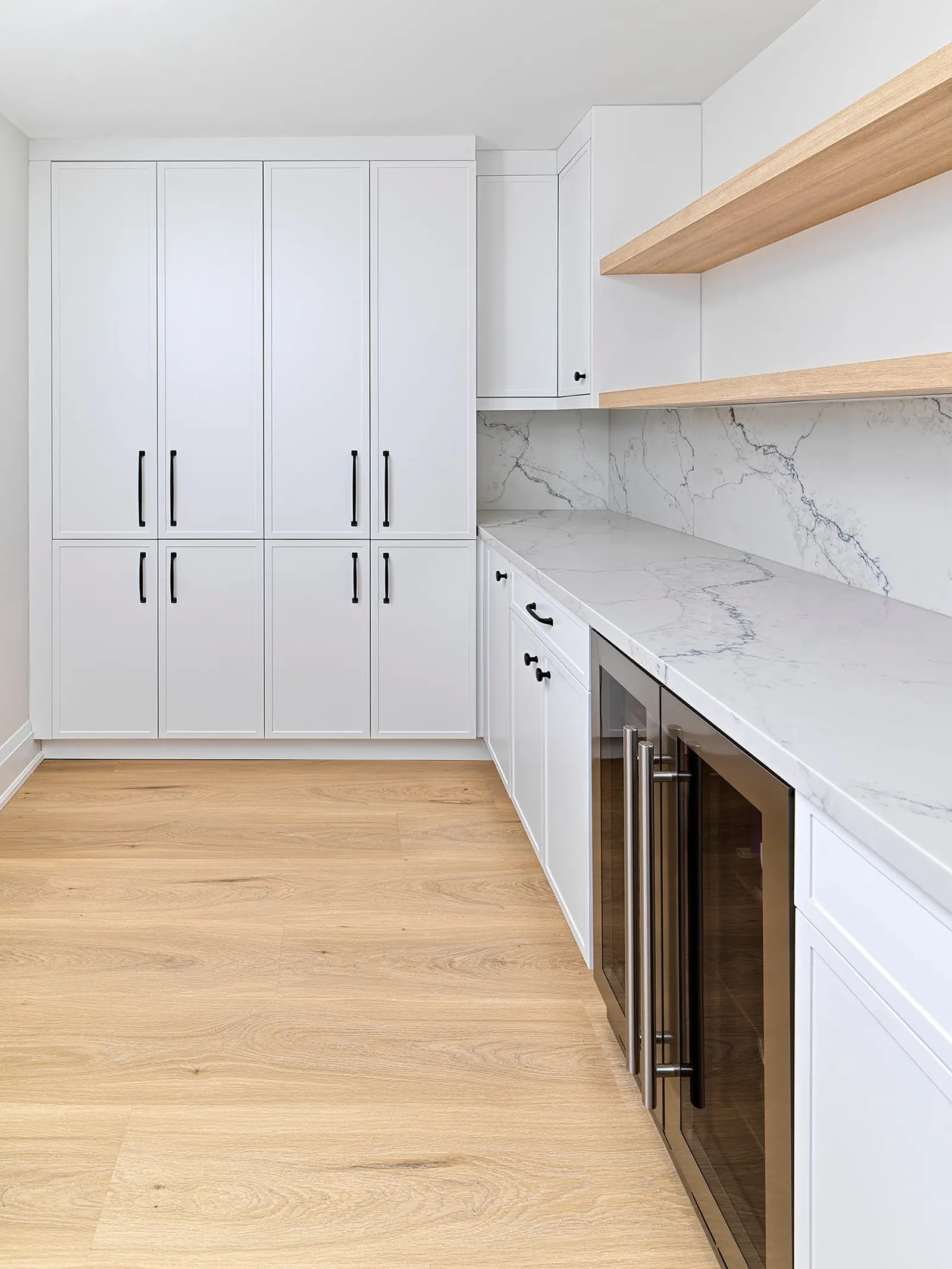Floor-to-ceiling pantry cabinets with a built-in wine fridge