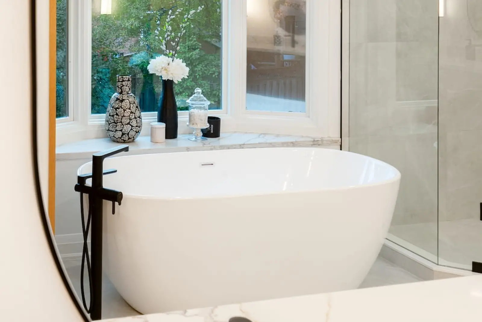 Freestanding tub with a black floor-mounted filler