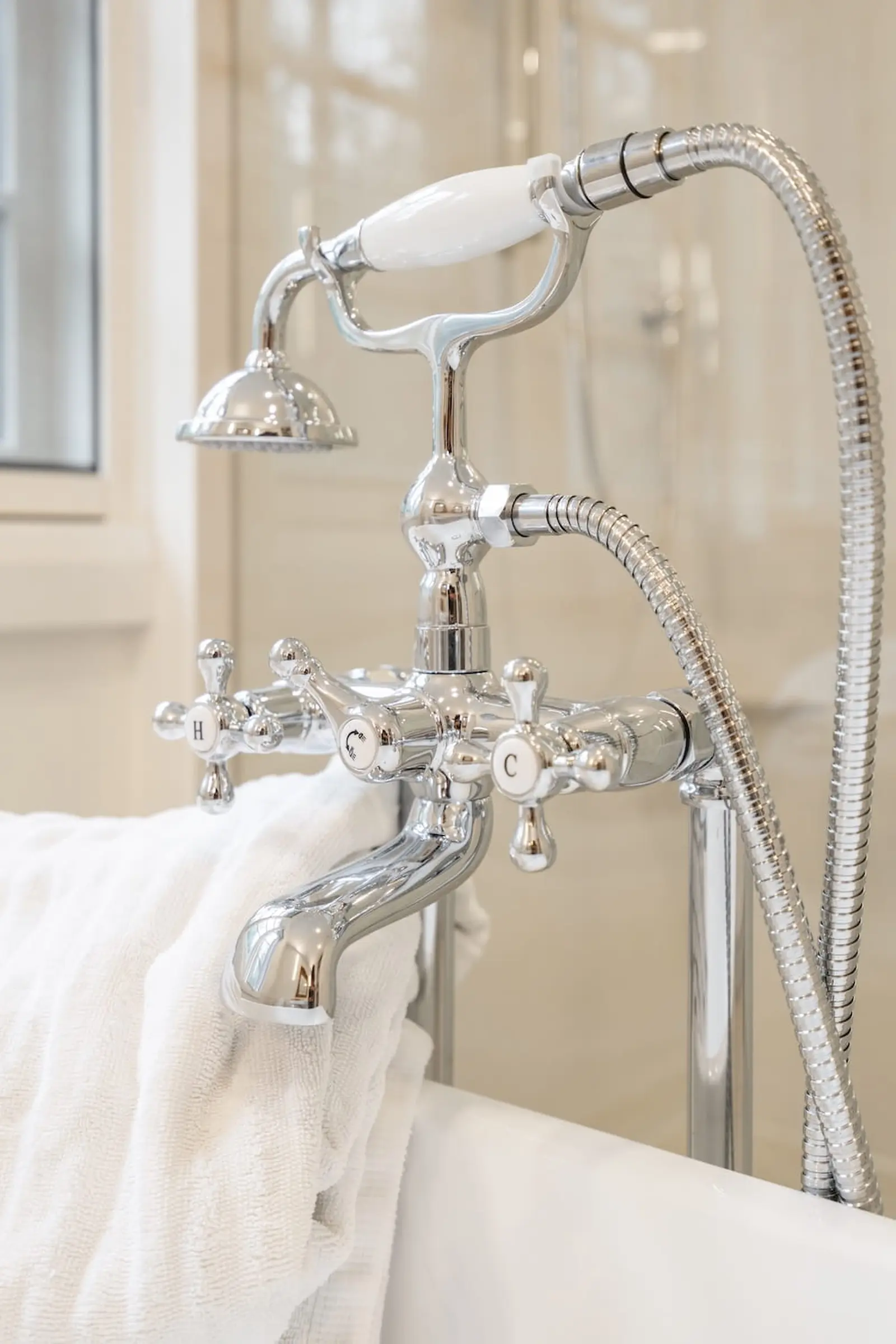 Polished chrome tub filler with cross handles