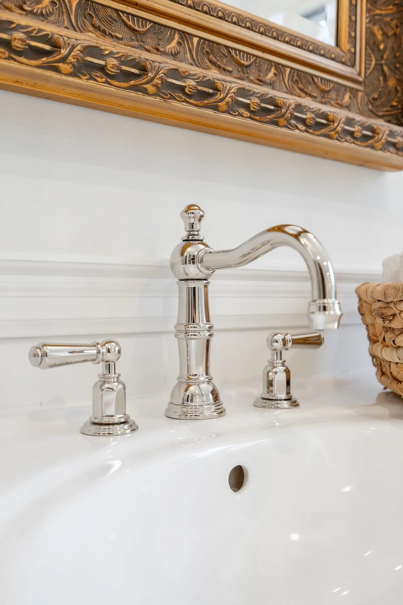 Polished nickel faucet on a white vanity