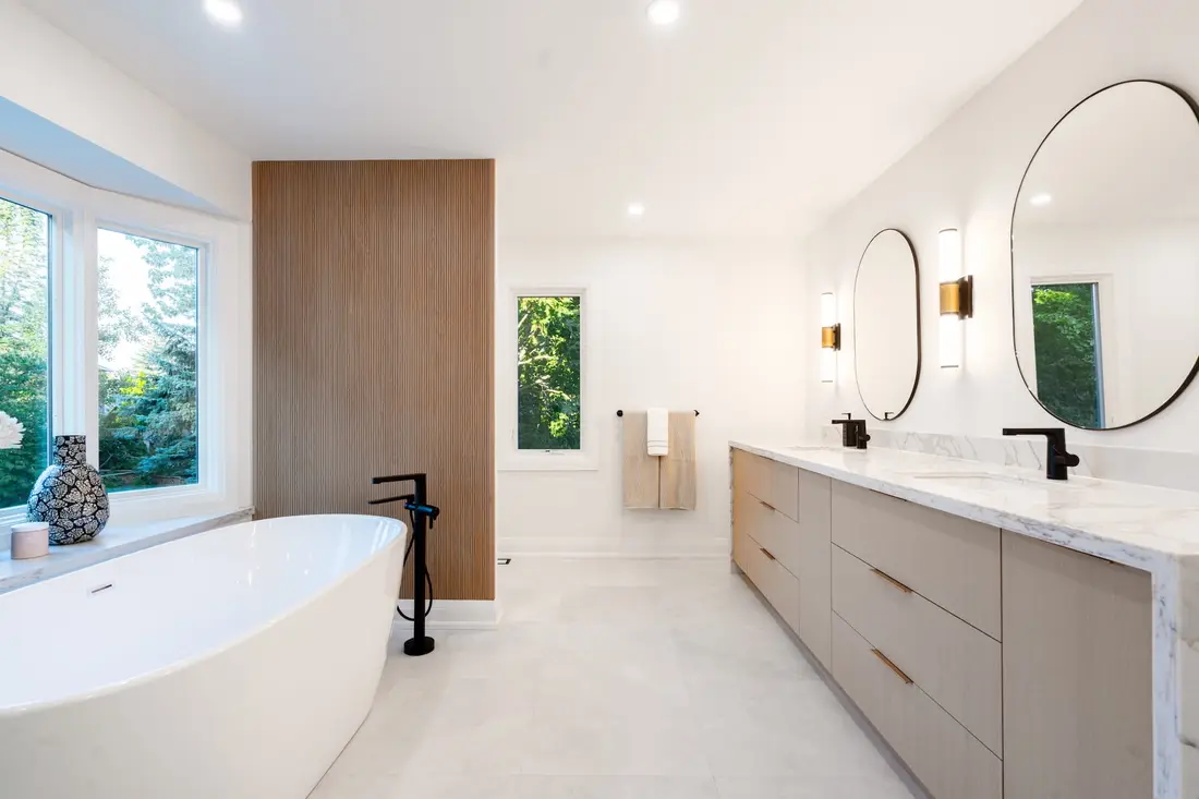 Bathroom with a freestanding tub and marble vanity near Guelph