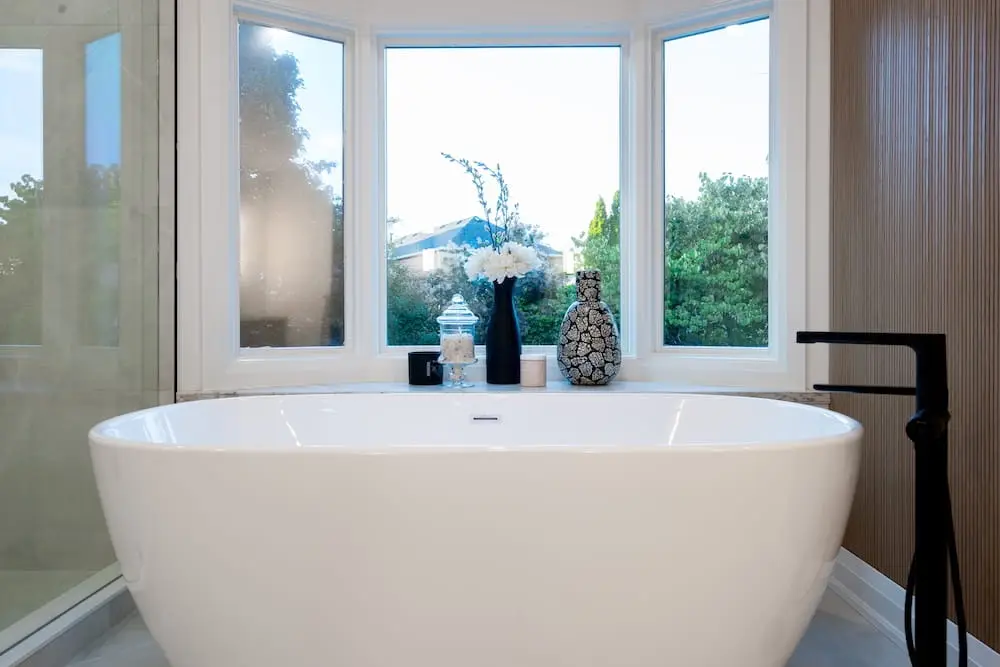 Renovated Toronto bathroom with a freestanding tub and black fixtures