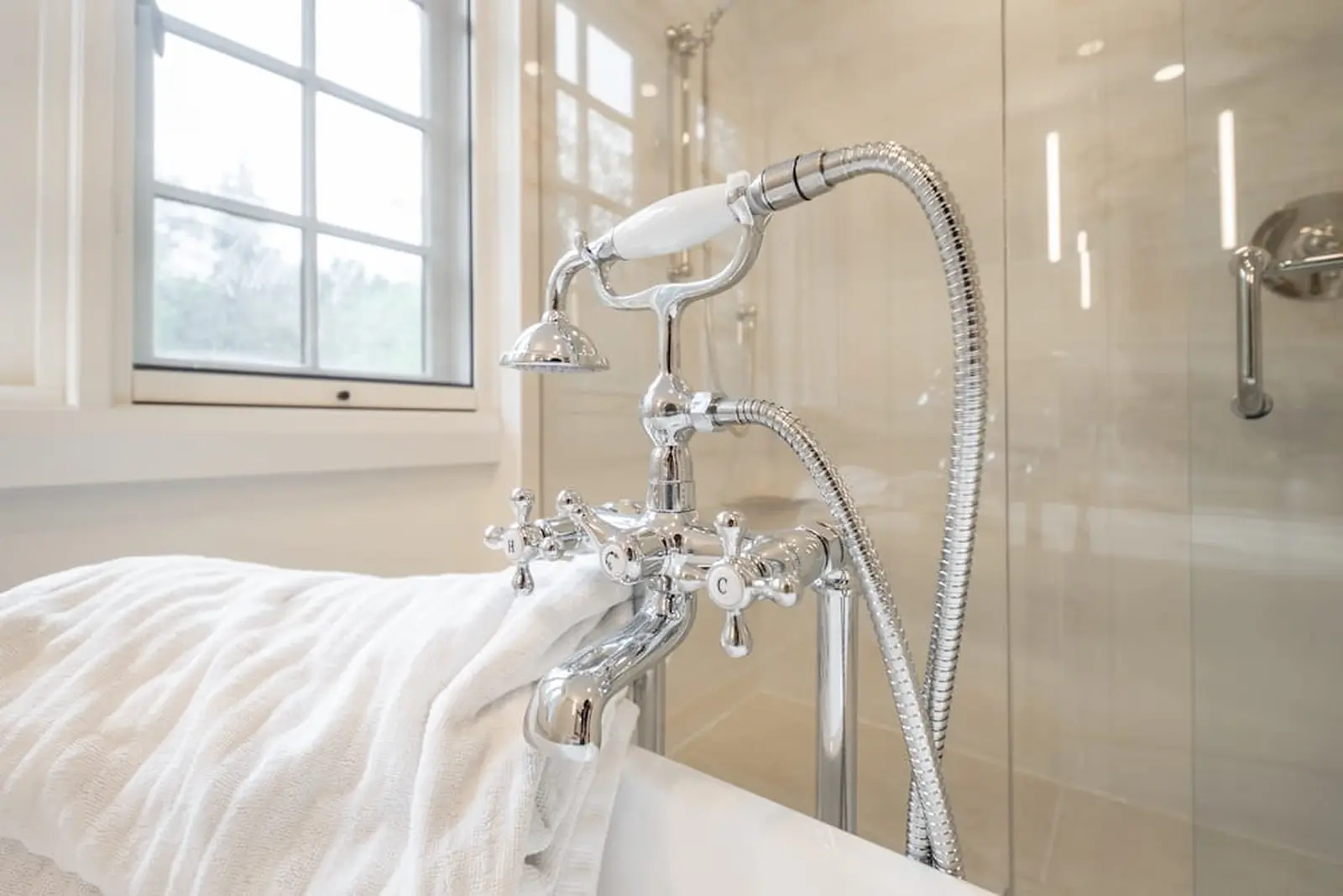 Polished chrome tub filler with a hand shower